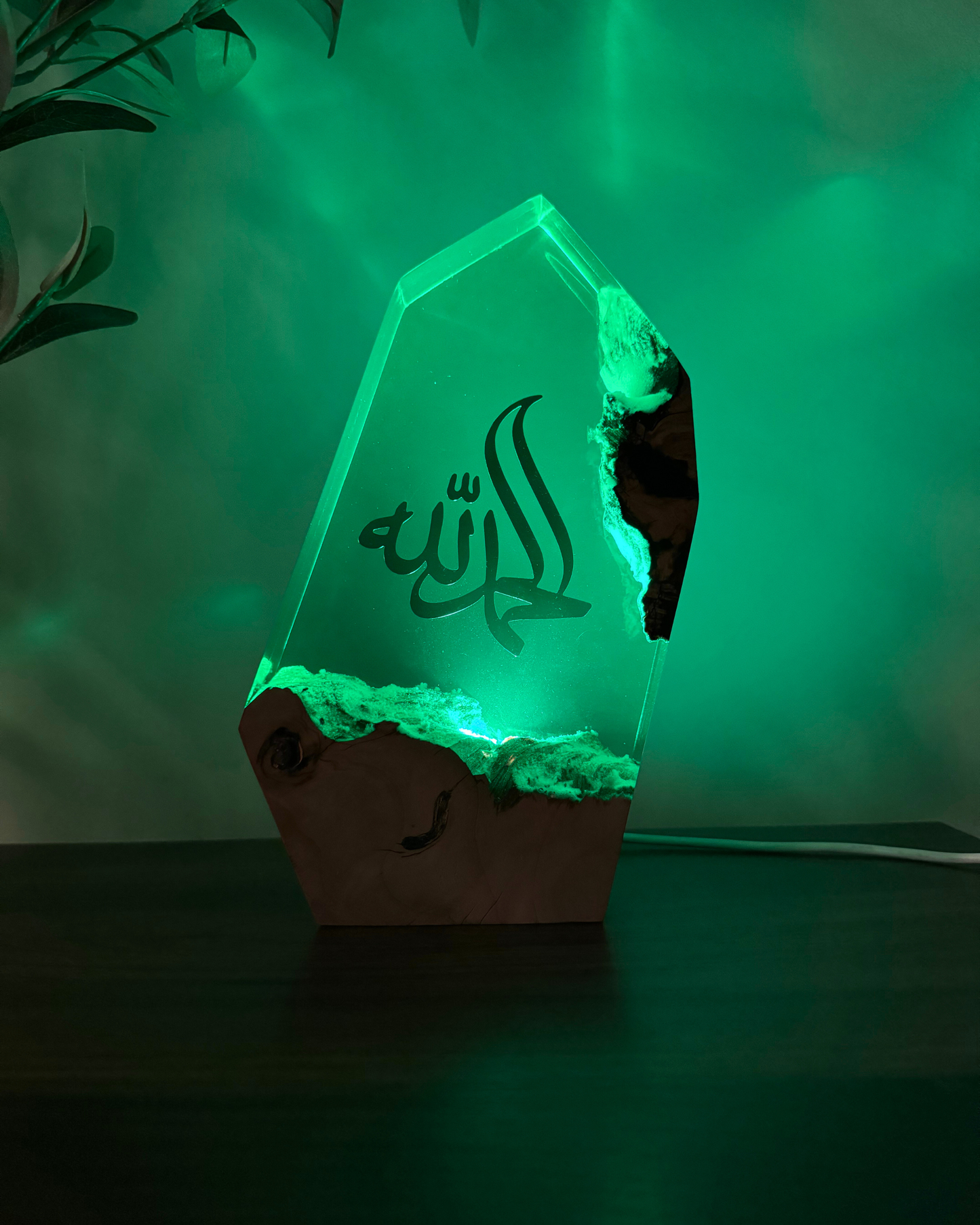 Luxury olive wood and resin sculpture glowing softly with LED light for nighttime display.