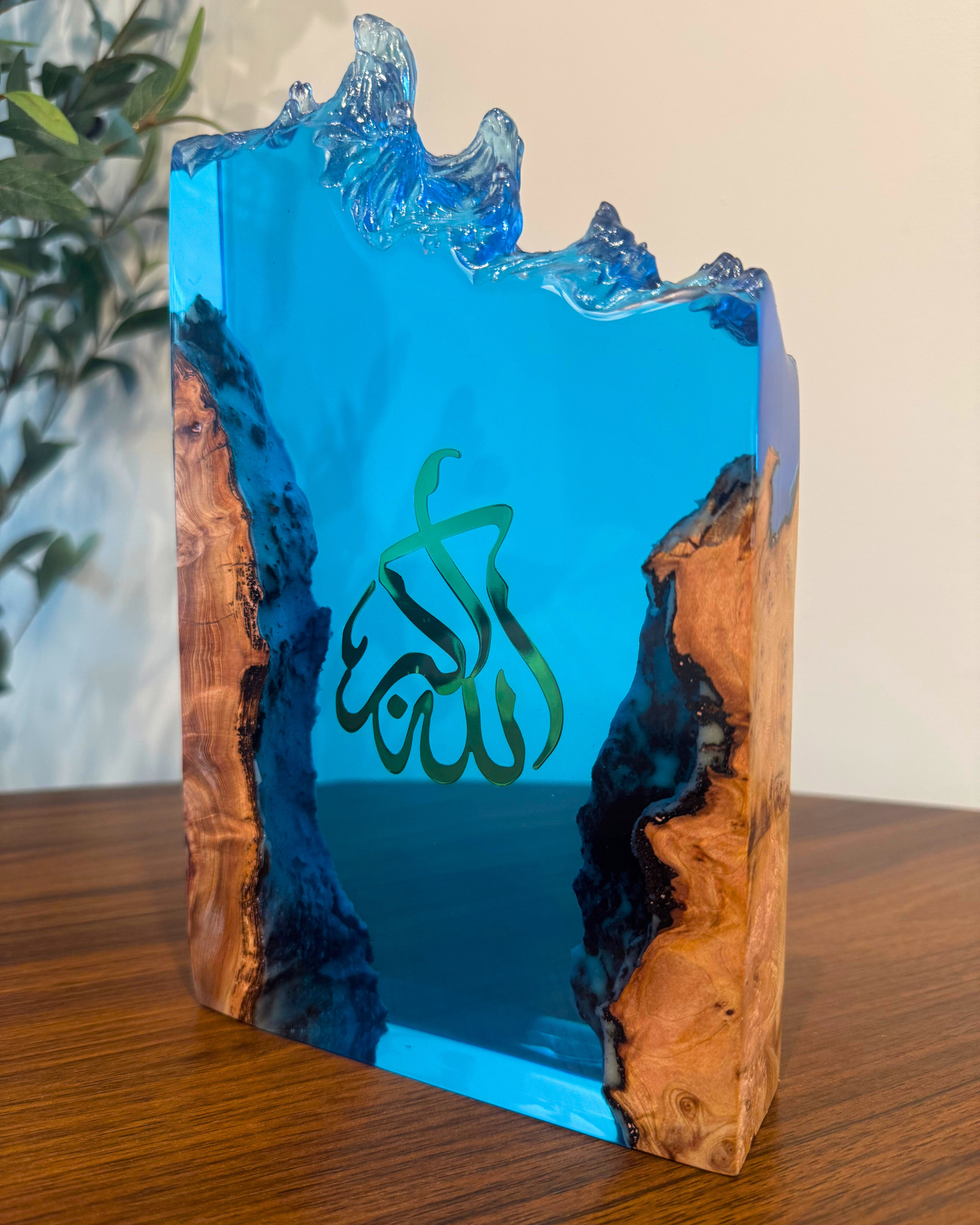 Blue resin and beech wood Islamic sculpture glowing under warm LED light.